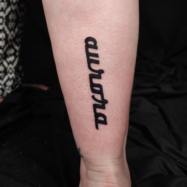 gonzalez in cursive tattoos